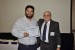 Dr. Nagib Callaos, General Chair, giving Mr. Iván Gutiérrez Agramont the best paper award certificate of the session "Cybersecurity." The title of the awarded paper is "Evaluation of Cryptographic Algorithms over an all Programmable SoC (AP SoC) Device."